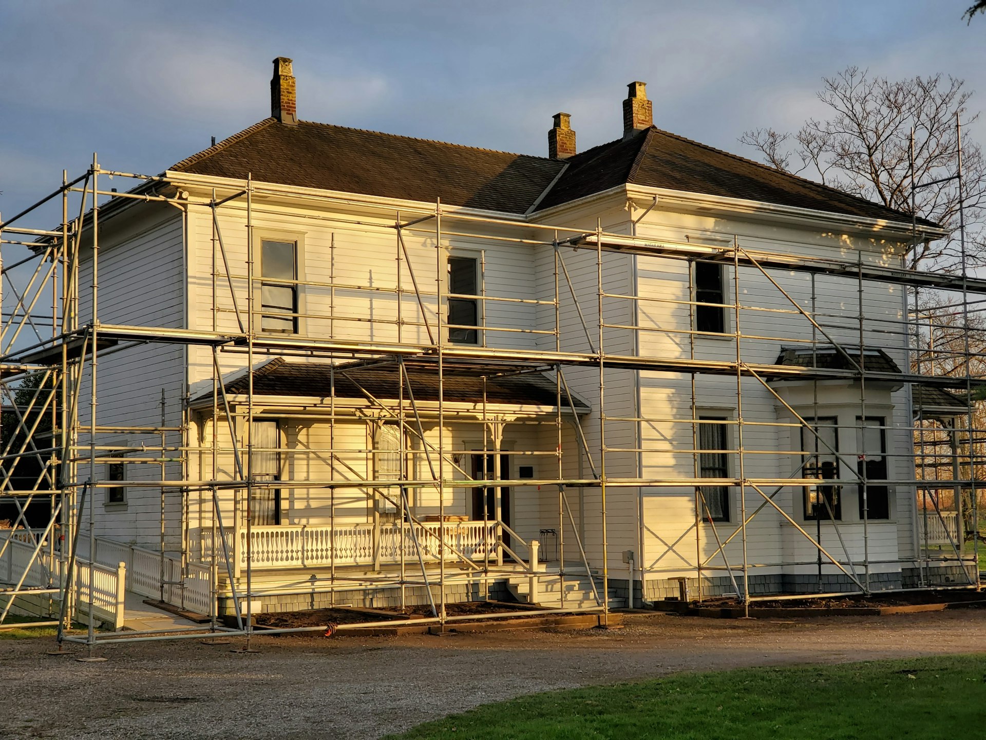 ASD SUNMOON Construction Companywhite wooden house near green grass field during daytime