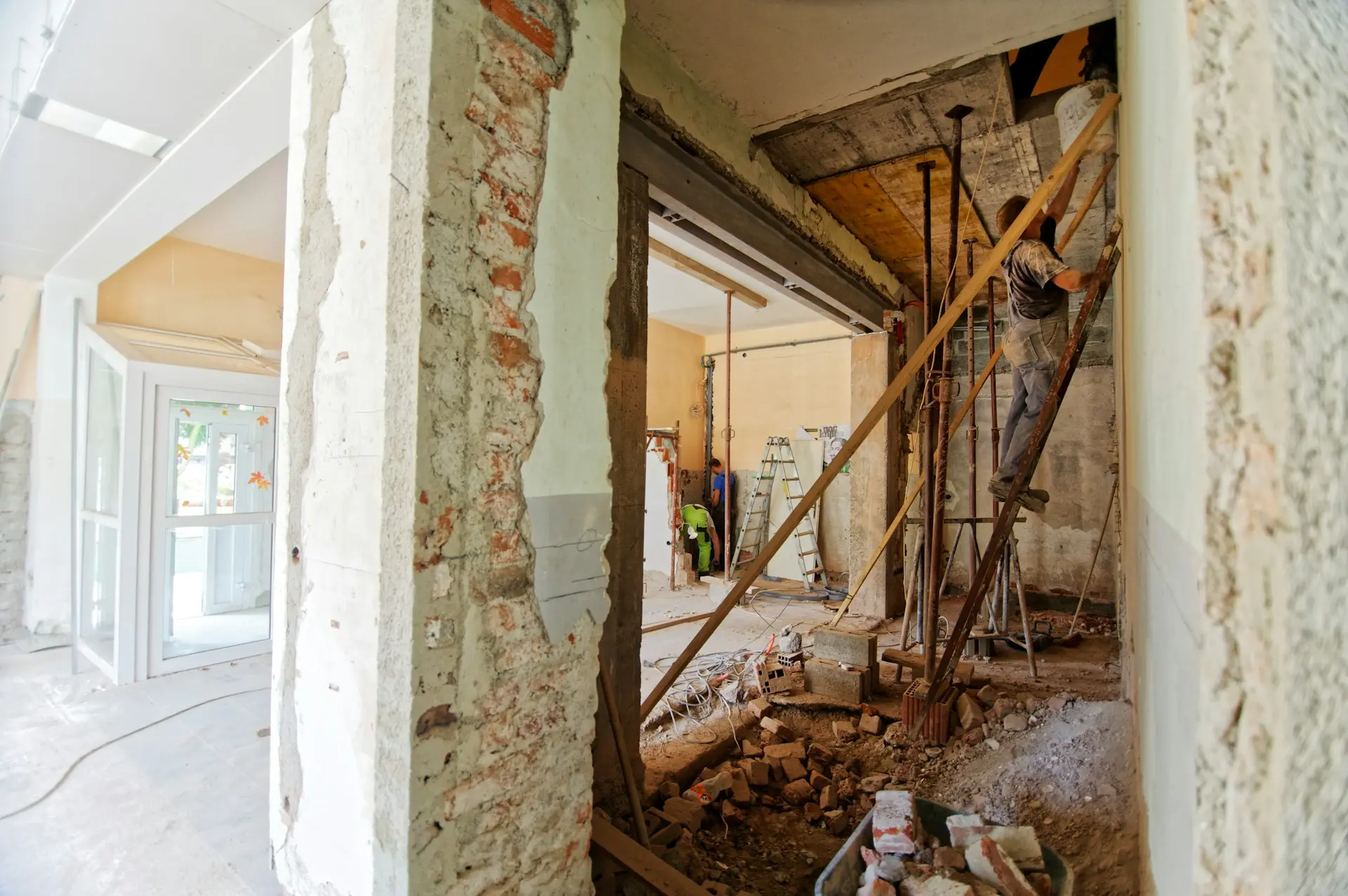 ASD SUNMOON Construction Company man climbing on ladder inside room